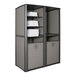 A grey and black Grosfillex outdoor storage unit with white towels on shelves.