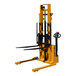 A yellow Big Joe walkie straddle stacker with black handles.