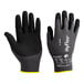 A pair of black and gray gloves with black palm coating and yellow foam nitrile tips.