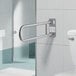 A Lavex swing-up grab bar with a satin finish on a white tile wall.