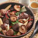 A bowl of soup with dried shiitake mushrooms.