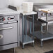 A Regency galvanized steel adjustable undershelf on a counter in a kitchen.