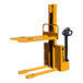 A Big Joe yellow warehouse stacker with a black handle.