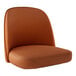 A Lancaster Table & Seating light brown vinyl bucket seat cushion on a brown chair.