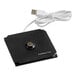 A black square object with a white cable.