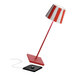 A Zafferano America Poldina Pro Lido table lamp with a red and white striped shade and black base.