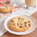 An Otis Spunkmeyer chocolate chunk cookie on a plate.