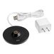 A black Zafferano America Pina Pro table lamp with a white charging cable on a counter.