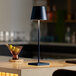 A Zafferano America Poldina Pro table lamp with a blue shade on a counter.