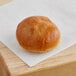 A Bridor Brioche Slider Roll on a piece of paper.