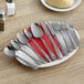 Choice Milton stainless steel spoons on a plate.
