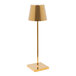 A Zafferano America Poldina Pro glossy gold table lamp with a white shade on a stand.