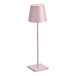 A Zafferano America Poldina Pro pink cordless table lamp with a white shade on a pole