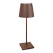 A brown Zafferano America Poldina Pro desk lamp on a metal base with a brown shade.