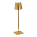 A Zafferano America Poldina Pro glossy gold table lamp on a stand with a white shade.