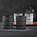 Two Nachtmann matte black rocks glasses on a table.