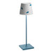 A Zafferano America Poldina Pro table lamp with a blue shade and blue fish design.