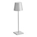 A white table lamp with a silver pole and a light on top of it.