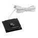 A black square USB cable plugged into a black square device.