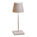 A white table lamp with a white shade.