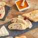 A slate board with sliced Bridor cranberry baguette.