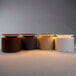 A group of dark gray Zafferano America PushUp Pro table lamps with round bases.