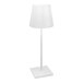 A Zafferano America Poldina Pro white cordless desk lamp with a white square base and pole with a white cylinder shade.