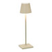 A white lamp with a sand shade on a white square base and a white pole