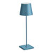 A Zafferano America Poldina Pro blue cylindrical lamp on a metal stand.