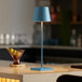 A Zafferano America Poldina Pro blue table lamp on a counter.