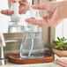 A person using a Dial foaming hand soap pump.