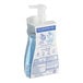 A bottle of Dial Spring Water foaming hand soap with a blue label and pump.