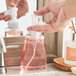 A person using a Dial foaming hand soap pump on a home kitchen counter.