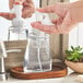 A hand holding a white Dial foaming hand soap pump.