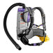 A ProTeam backpack vacuum with a hose attached to it.