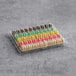 A box of colorful macarons on a white background.