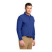 A man wearing a Port Authority® royal blue long sleeve polo shirt.