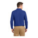 A man wearing a Port Authority® royal blue long sleeved polo shirt.