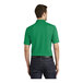 A man wearing a bright kelly green Port Authority polo shirt.