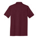 A close-up of a maroon Port & Company short sleeve polo shirt.