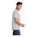 A man in a medium Port & Company ash grey short sleeve t-shirt smiling.