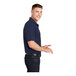 A man wearing a navy blue Sport-Tek short sleeve polo.