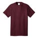A Port & Company maroon short sleeve t-shirt with a white collar.