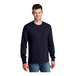 A man wearing a Port & Company long sleeve navy t-shirt.