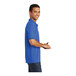 A man wearing a royal blue Port & Company polo shirt.