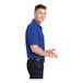 A man wearing a Sport-Tek true royal blue short sleeve polo shirt.