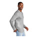 A man wearing a light heather grey long sleeve District T-shirt.