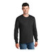 A man wearing a Port & Company black long sleeve t-shirt.