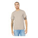A man with tattoos wearing a Bella + Canvas heather dust short sleeve t-shirt.