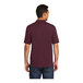 A man wearing a Port & Company unisex maroon polo shirt.